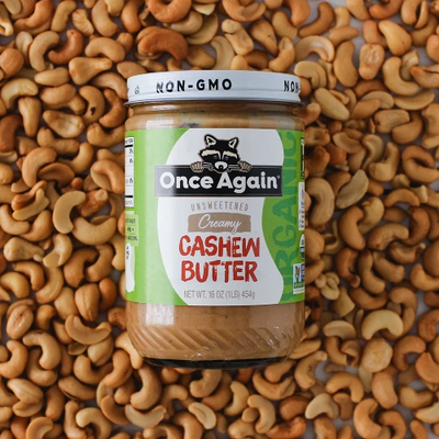 A jar of Once Again Cashew Butter on a pile of cashews